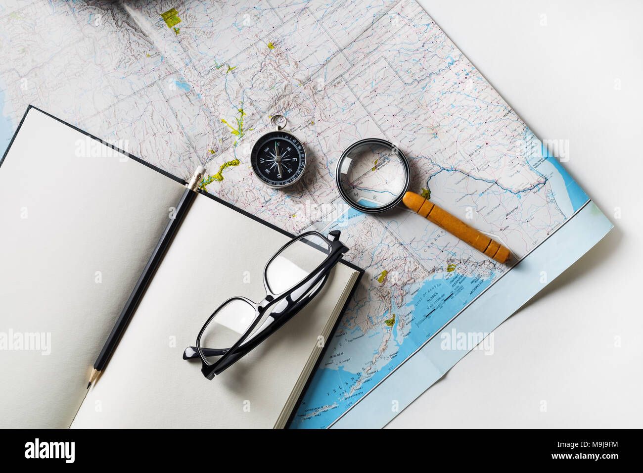 Travel planner's notebook with map, compass and camera — planning a Sambhajinagar trip